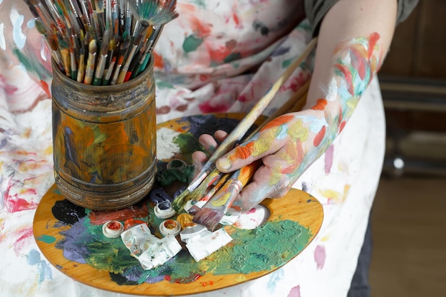 Female artist hands with paint brushes