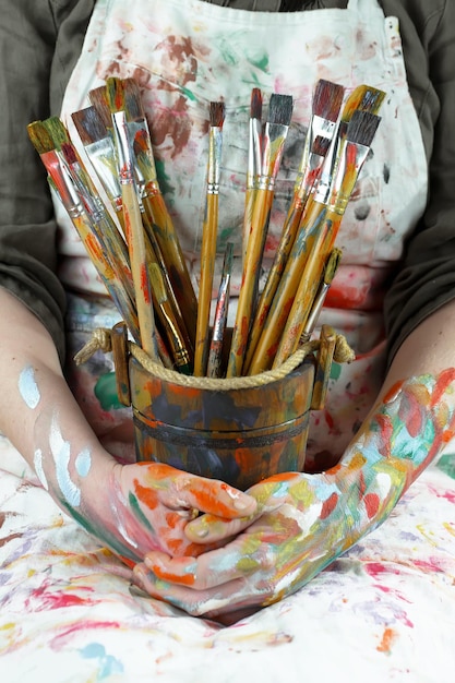 Female artist hands with paint brushes