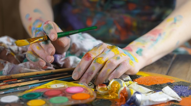 Female artist hands with paint brushes