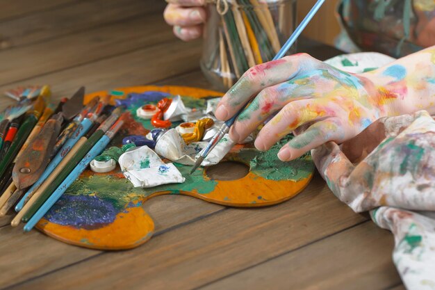 Female artist hands with paint brushes