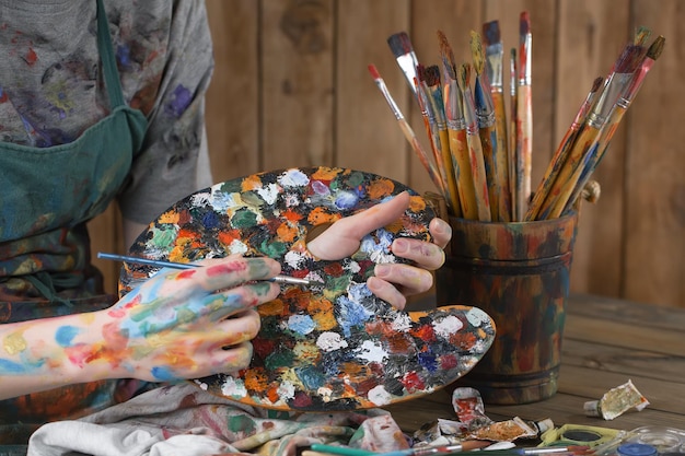 Female artist hands with paint brushes