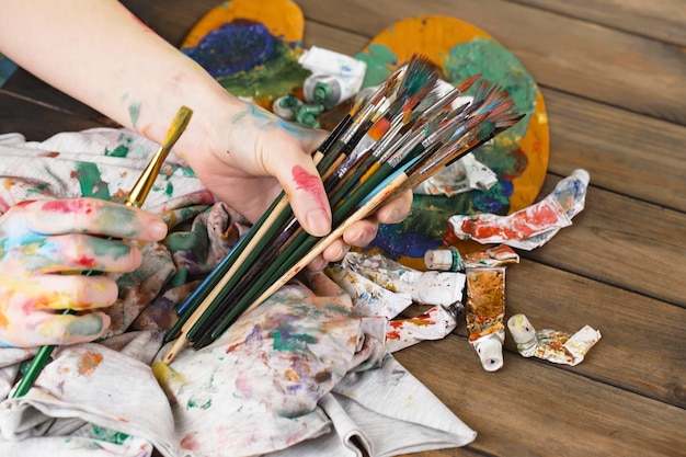 Female artist hands with paint brushes