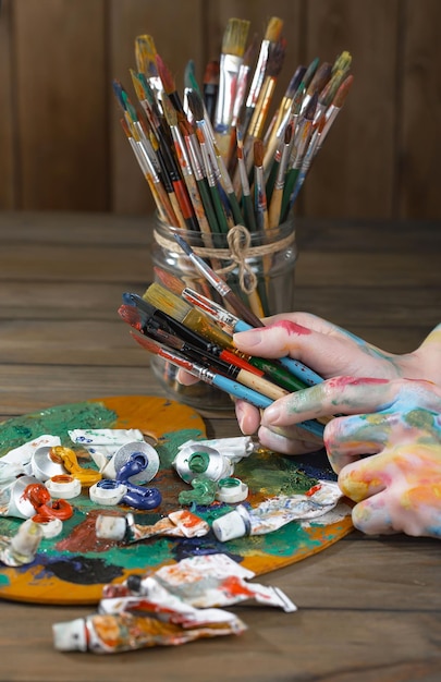 Female artist hands with paint brushes