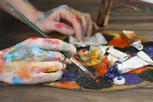 Female artist hands with paint brushes