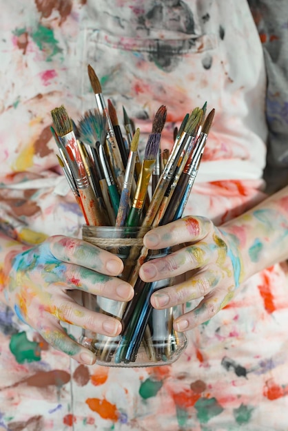 Female artist hands with paint brushes