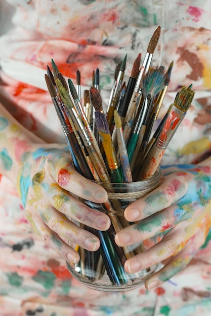 Female artist hands with paint brushes