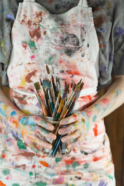 Female artist hands with paint brushes