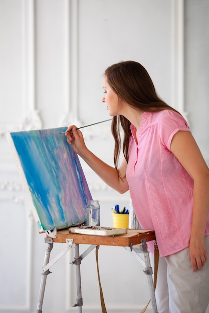 Female artist with brush and paint palette 