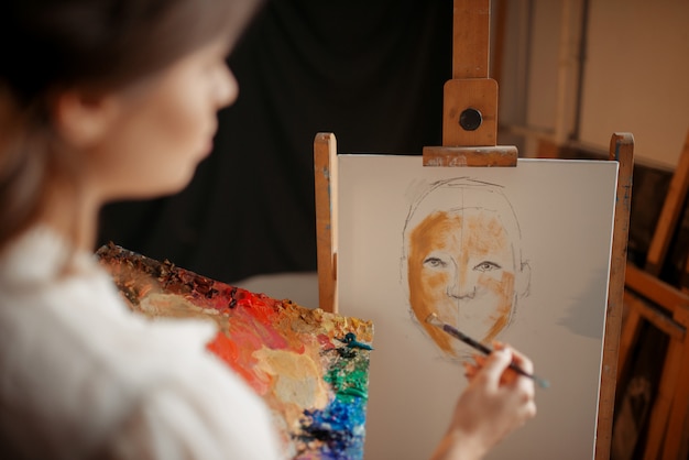 Female artist with color palette and brush