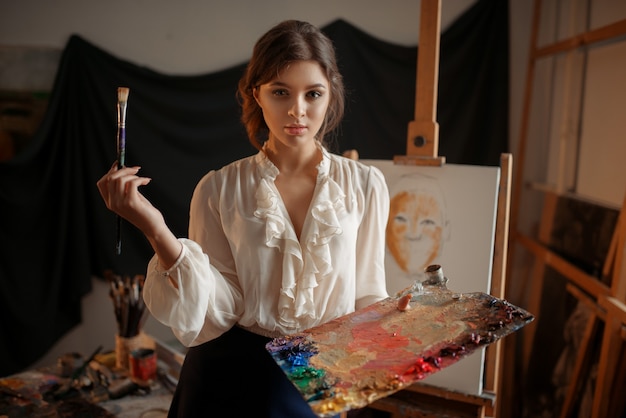 Female artist with color palette and brush