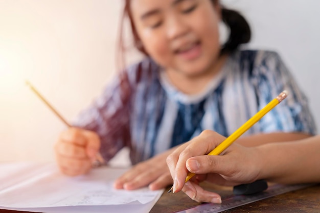 Female Asian student studying with a closeup teacher teacher holding a pencil Education concept