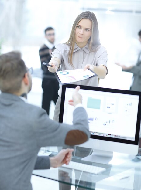 Female assistant gives the employee a financial document.office weekdays