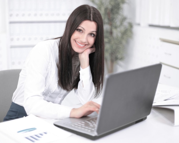 Female assistant working on laptop in the office