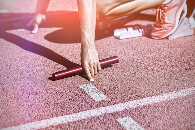 Female athlete ready to start relay race