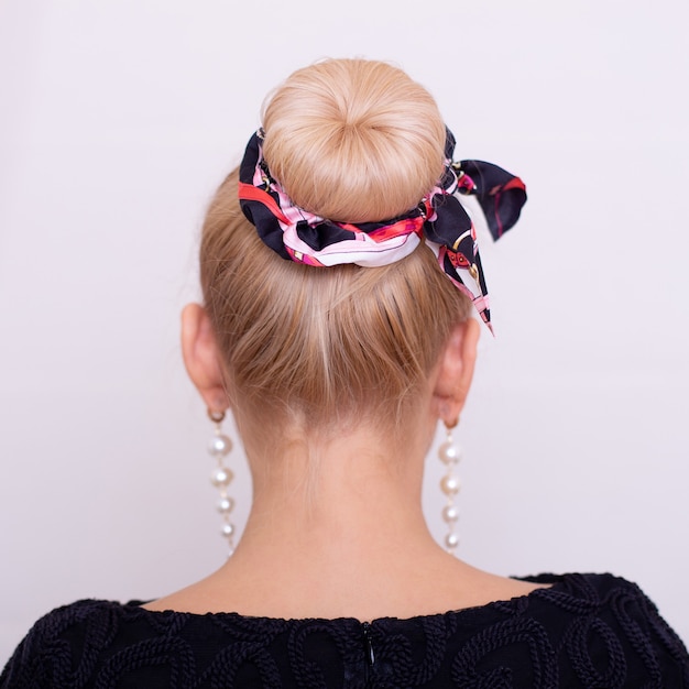 Female back with blonde hair style and fashion band