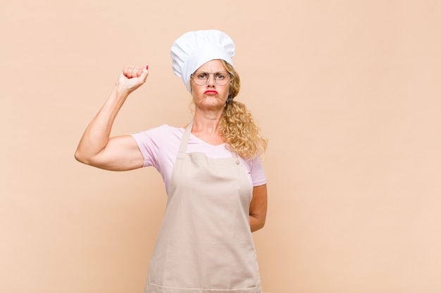 Female baker feeling serious, strong and rebellious