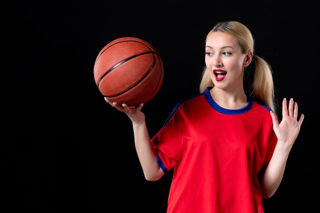 female basketball player in sport clothes with ball on black background game athlete