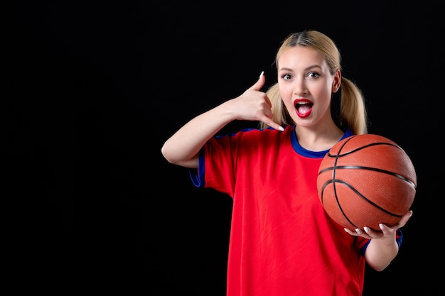 female basketball player in sport clothes with ball on black background game exercise athletes