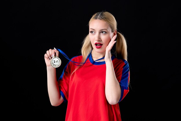 female basketball player with golden medal on the black background athlete game winner trophy