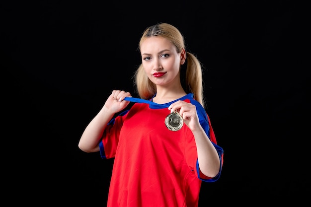 female basketball player with golden medal on a black background trophy winner game athlete