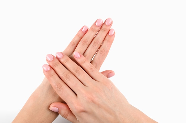 Female beautiful hands with manicure on an isolated white