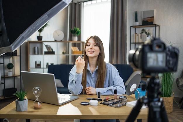 Female beauty blogger recording online tutorial on camera