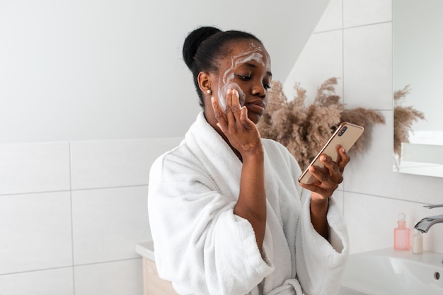 Female beauty blogger shooting video tutorial in bathroom