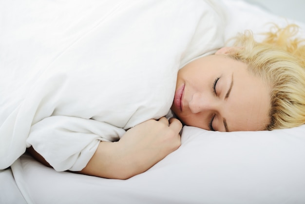 Female on bed in bedroom sleeping