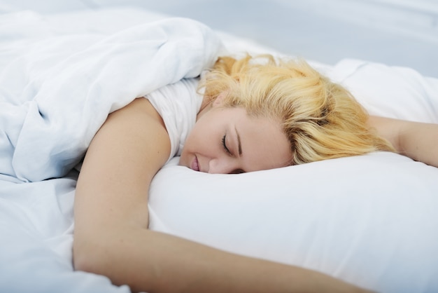 Female on bed in bedroom sleeping