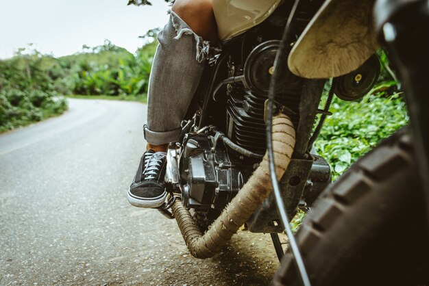 Female biker driving a cafe racer motorbike