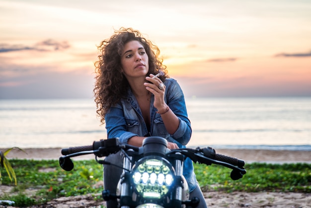 Female biker driving a cafe racer motorbike