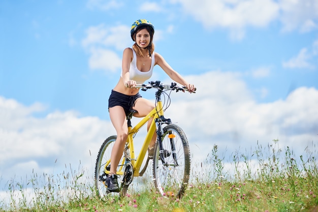 female biker riding on mountain bicycle