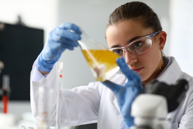 Female biochemist analyzing sample