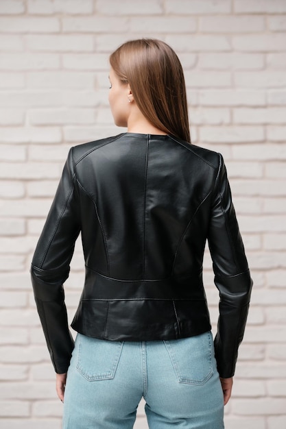 Female in black a leather jacket and blue jeans