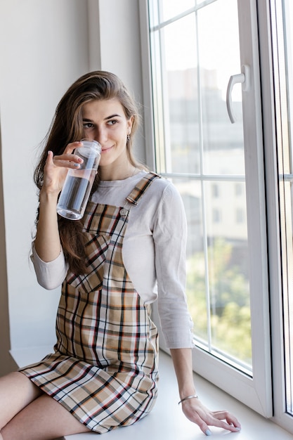 Female blogger drinks water during break