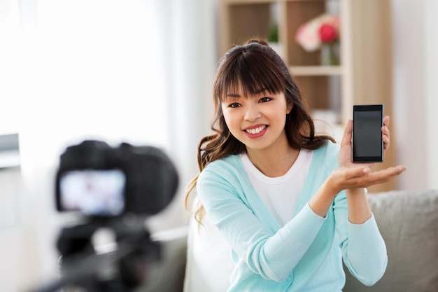 female blogger makes video blog of smartphone