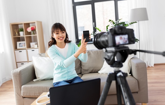 female blogger makes video blog of smartphone