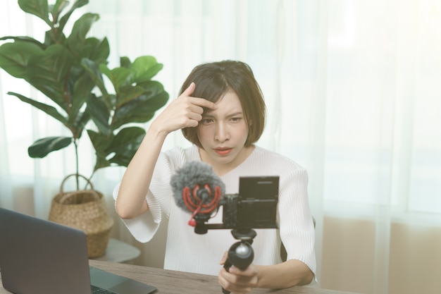 Female blogger recording broadcast video at home
