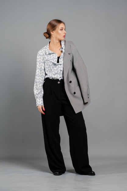 Female in a blouse and trousers Studio portrait