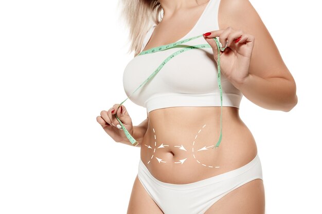 Photo female body with the drawing arrows. fat lose, liposuction and cellulite removal concept. marks on the woman before plastic surgery. image is not body shape retouched