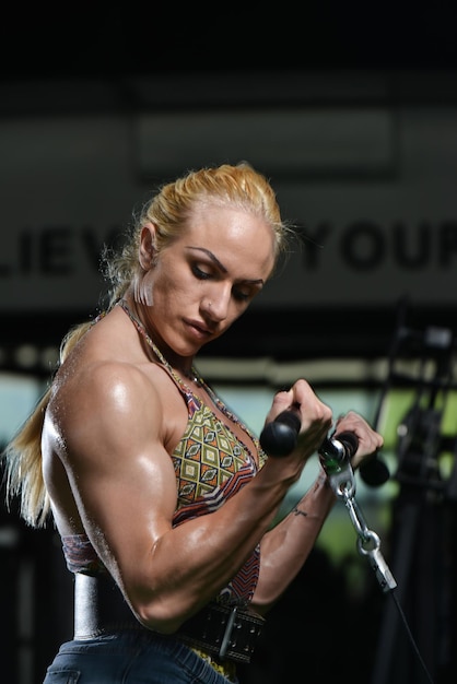 Female Bodybuilder Doing Heavy Weight Exercise For Biceps