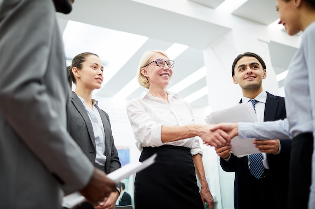 Female Boss Greeting Partner