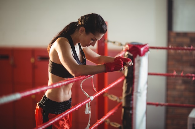 Female boxer standing in boxing ring