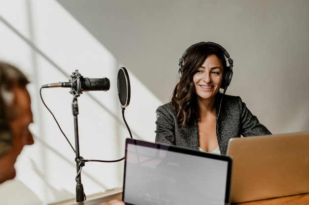 Female broadcaster interviewing her guest in a studio