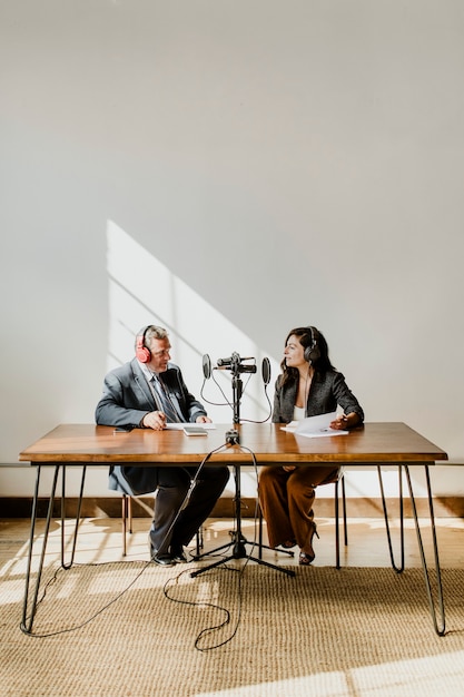 Female broadcaster interviewing her guest in a studio