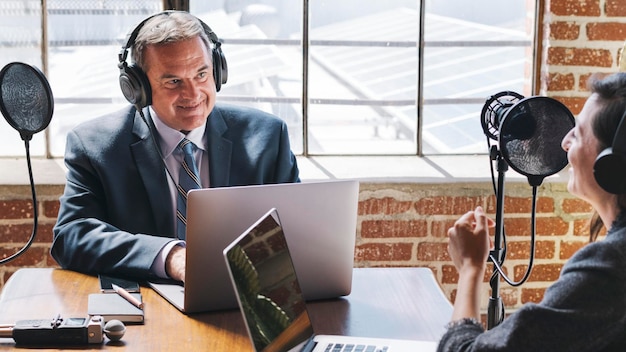 Female broadcaster interviewing her guest in a studio