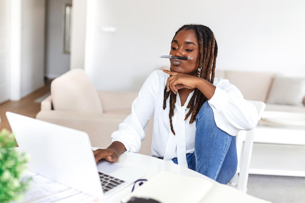 Female businessmen in casual wear work at the desk about accounting and business plan analysis Young black woman at her desk in an office Graphs and charts