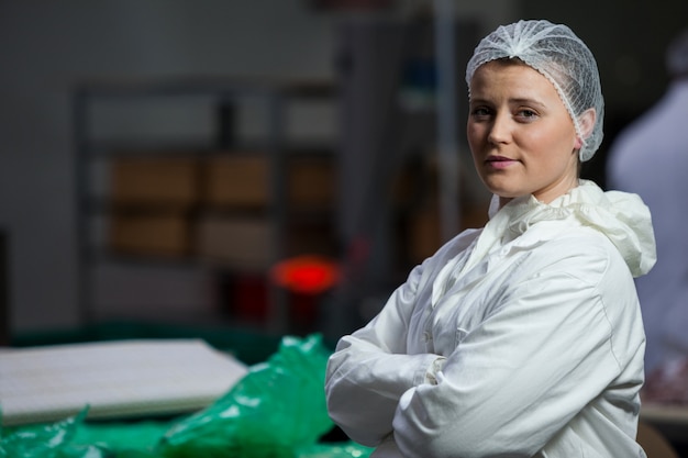 Female butcher standing with arms crossed