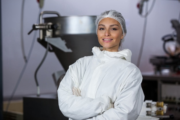 Female butcher standing with arms crossed