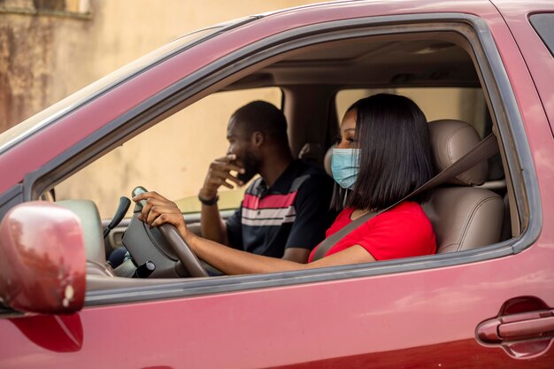 female cab driver wearing nose with her male passenger